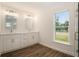 Bathroom featuring double sink vanity and a window at 106 Ne 1St Ave, Lutz, FL 33549