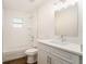 Bright bathroom featuring modern fixtures, a tiled shower-tub, and wood-look flooring at 106 Ne 1St Ave, Lutz, FL 33549