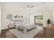 Cozy bedroom featuring natural light, hardwood floors, and sliding door to backyard at 106 Ne 1St Ave, Lutz, FL 33549