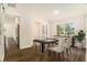 Bright dining room with wood floors, dining table, and open access to the kitchen at 106 Ne 1St Ave, Lutz, FL 33549