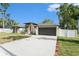 Charming single-story home with a well-manicured lawn and inviting entrance with a gray two-car garage at 106 Ne 1St Ave, Lutz, FL 33549