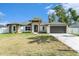 Charming single-story home with a well-manicured lawn and inviting entrance with a two-car garage at 106 Ne 1St Ave, Lutz, FL 33549