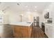 Spacious kitchen area with white quartz countertops, stainless steel appliances, and hardwood floors at 106 Ne 1St Ave, Lutz, FL 33549