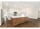 Modern kitchen featuring stainless steel appliances, white cabinets, and a center island at 106 Ne 1St Ave, Lutz, FL 33549