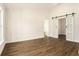 Bright living room featuring hardwood floors, large windows, and modern sliding barn doors at 106 Ne 1St Ave, Lutz, FL 33549