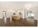 Open floor plan view featuring kitchen island, natural light, and hardwood floors at 106 Ne 1St Ave, Lutz, FL 33549