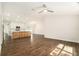 Open-concept space with hardwood floors and a kitchen with an island, cabinets and appliances at 106 Ne 1St Ave, Lutz, FL 33549