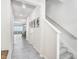 Inviting hallway with neutral walls, tile flooring, and staircase, seamlessly connecting the home's different spaces at 11717 Blackbrook Ct, Seffner, FL 33584