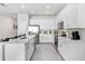 Bright, modern kitchen with white cabinets, stainless steel appliances, a large island, and sleek countertops at 11717 Blackbrook Ct, Seffner, FL 33584