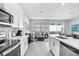 Stylish open kitchen with stainless steel appliances, granite countertops, and seamless transition into living space with lots of light at 11717 Blackbrook Ct, Seffner, FL 33584