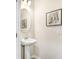 Cozy powder room with pedestal sink, decorative mirror, and modern fixtures, perfect for guests at 11717 Blackbrook Ct, Seffner, FL 33584