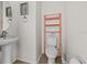 Cozy half bathroom with modern fixtures, a pedestal sink, and a clean, simple design at 11841 Thicket Wood Dr, Riverview, FL 33579