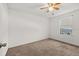 Standard bedroom with ceiling fan and window, offering comfortable and simple living space at 11841 Thicket Wood Dr, Riverview, FL 33579