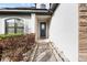 Inviting front entrance with a stylish door, stone accents, and manicured landscaping at 11841 Thicket Wood Dr, Riverview, FL 33579