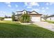Charming two-story home featuring a well-manicured lawn, stone accents, and a two-car garage at 11841 Thicket Wood Dr, Riverview, FL 33579