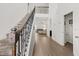 Elegant foyer featuring a staircase with decorative iron railings and hardwood floors at 11841 Thicket Wood Dr, Riverview, FL 33579