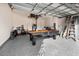 Spacious garage features an epoxy floor and includes a pool table for entertainment at 11841 Thicket Wood Dr, Riverview, FL 33579