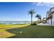 Expansive backyard with manicured lawn, palm trees, and lake views at 11854 Lake Lucaya Dr, Riverview, FL 33579