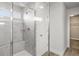 Modern bathroom featuring a glass-enclosed shower with tiled walls, a built-in bench, and a separate door at 11854 Lake Lucaya Dr, Riverview, FL 33579