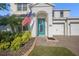 Inviting front entrance with a bright turquoise door, brick walkway, and well-maintained landscaping at 11854 Lake Lucaya Dr, Riverview, FL 33579