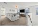 Bright living room featuring a plush gray sofa, stylish decor, and a large television for comfortable, modern living at 11854 Lake Lucaya Dr, Riverview, FL 33579