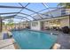 Inviting screened-in pool with lounge chairs, and a covered patio area, perfect for entertaining at 11854 Lake Lucaya Dr, Riverview, FL 33579