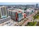 A vibrant aerial view featuring modern apartment buildings, parking garages, and city streets at 1208 E Kennedy Blvd # 1125, Tampa, FL 33602