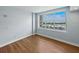 Bright bedroom featuring wood floors, modern finishes, and a large window with city views at 1208 E Kennedy Blvd # 1125, Tampa, FL 33602