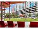 Lounge chairs beneath a modern shade structure in the community gathering space of a colorful building complex at 1208 E Kennedy Blvd # 1125, Tampa, FL 33602