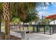 Community dog park surrounded by palm trees, a sidewalk, and a modern building in the background at 1208 E Kennedy Blvd # 1125, Tampa, FL 33602