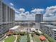 Modern building complex features amenities like tennis court, dog park, and green spaces at 1208 E Kennedy Blvd # 1125, Tampa, FL 33602