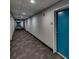 A long hallway with carpet and neutral walls, lit by recessed lighting and apartment doors at 1208 E Kennedy Blvd # 1125, Tampa, FL 33602