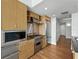 Well-equipped kitchen with stainless steel appliances and wood cabinets near hallway at 1208 E Kennedy Blvd # 1125, Tampa, FL 33602