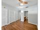 Light and airy main bedroom featuring wood floors, ceiling fan, and an ensuite bathroom for a relaxing retreat at 1208 E Kennedy Blvd # 1125, Tampa, FL 33602