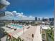 Rooftop pool with lounge chairs, tables, and views of the city skyline at 1208 E Kennedy Blvd # 1125, Tampa, FL 33602