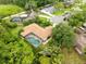 An aerial view shows a home with a screened-in pool, a well-kept yard and mature trees, in a desirable neighborhood at 12217 Snead Pl, Tampa, FL 33624