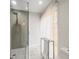 Modern bathroom with glass shower, marble floors, and a window for natural light at 12217 Snead Pl, Tampa, FL 33624