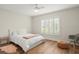 Bright bedroom with hardwood floors features a bed, window with shutters, and modern furnishings at 12217 Snead Pl, Tampa, FL 33624