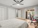 Spacious bedroom with ceiling fan, hardwood floors, and a sliding glass door leading to the patio at 12217 Snead Pl, Tampa, FL 33624