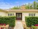Front entrance featuring double doors, stone accents, manicured hedges and exterior lighting at 12217 Snead Pl, Tampa, FL 33624