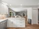 Modern kitchen featuring white cabinets, sleek countertops, and an open layout into the living area at 12217 Snead Pl, Tampa, FL 33624