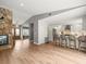Open-concept living room showing the stone fireplace and kitchen with island seating at 12217 Snead Pl, Tampa, FL 33624