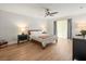 Bright main bedroom with ceiling fan, hardwood floors, and black bedside tables at 12217 Snead Pl, Tampa, FL 33624