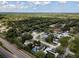 Beautiful aerial of home near mature trees with a pool in Dunedin, Florida at 1326 Moss Dr, Dunedin, FL 34698