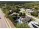 Lovely aerial view of home with pool, solar panels, and lush landscaping in Dunedin, Florida at 1326 Moss Dr, Dunedin, FL 34698
