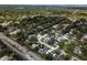 Picturesque aerial of homes surrounded by verdant trees, near a road in Dunedin, Florida at 1326 Moss Dr, Dunedin, FL 34698