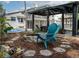 Inviting backyard with a stone firepit, covered outdoor seating, and a basketball court at 1326 Moss Dr, Dunedin, FL 34698