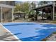 Backyard features a basketball court, swimming pool, and covered outdoor seating areas at 1326 Moss Dr, Dunedin, FL 34698