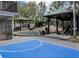 Backyard includes a basketball court, swimming pool, cabanas, and lounge chairs at 1326 Moss Dr, Dunedin, FL 34698