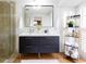 Modern bathroom with a double sink dark vanity, decorative plants, a mirror, and a glass shower door at 1326 Moss Dr, Dunedin, FL 34698
